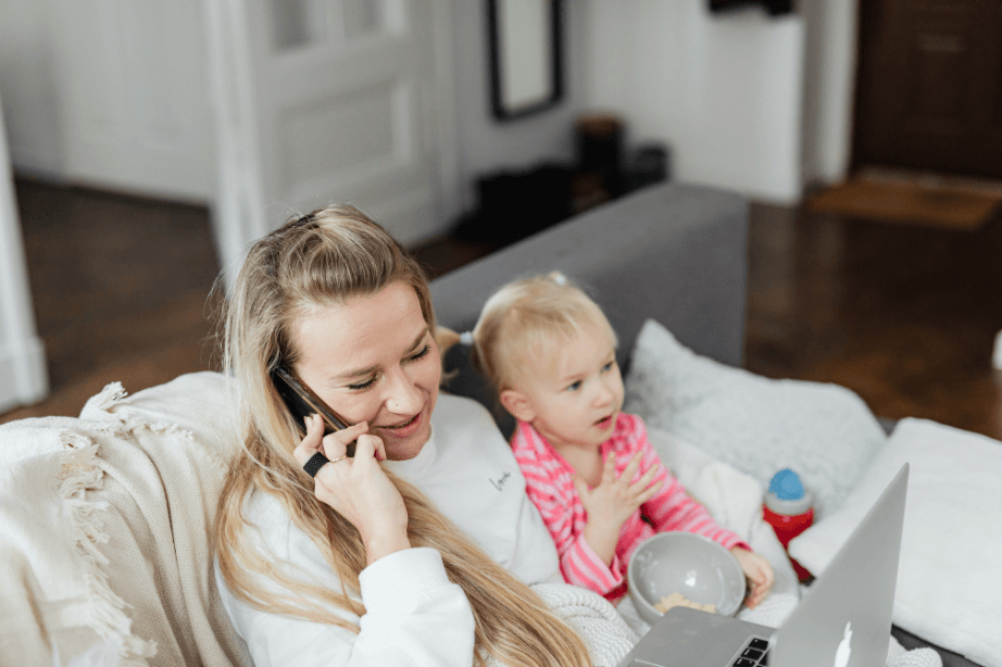 Mother on phone consultation with daughter nearby